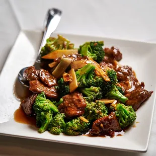 beef and broccoli on a white plate