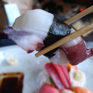 a plate of sushi and chopsticks