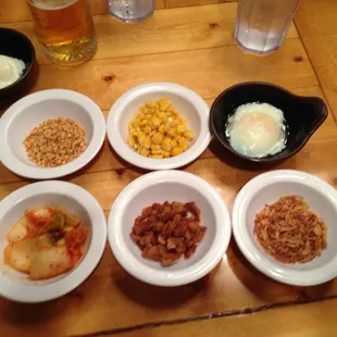 Side dish combos to add to the ramen dish - kimchi, garlic, pork bits, poached egg, fried onion!
