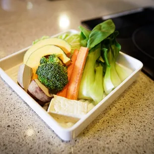 ows a bowl of vegetables