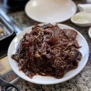 a plate of beef and onions