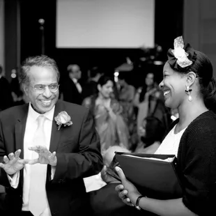 Owner and Event Planner, Jessica Harris, speaking to an enthusiastic Father of the Bride.