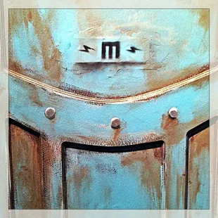 a close up of a rusted metal door