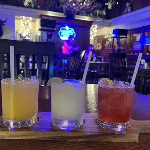 three cocktails on a table