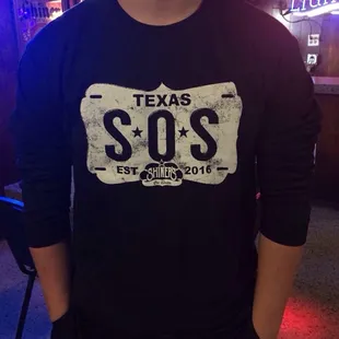 a man wearing a texas sos shirt