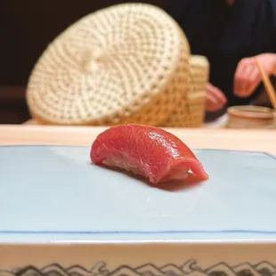 a person cutting a piece of sushi