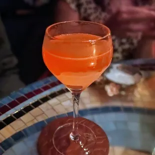 a glass of orange juice on a table