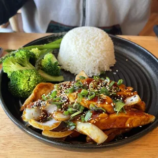 a plate of food with rice and broccoli