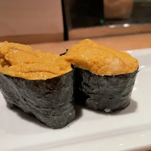 two pieces of sushi on a plate