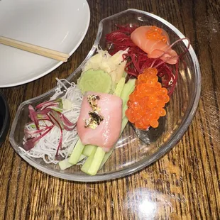 a plate of sushi and vegetables