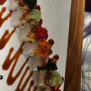 a plate of sushi with sauce on it