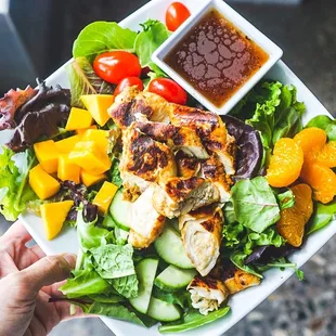 a person holding a plate of food