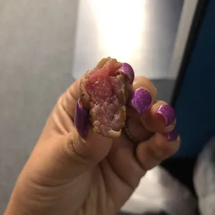 a hand holding a piece of food