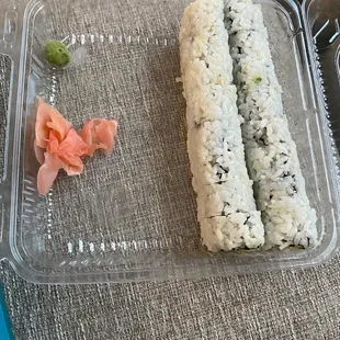 a sushi roll and a piece of salmon