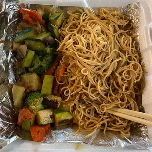 noodles and vegetables in a styrofoam container