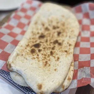 a flat bread on a checkered napkin