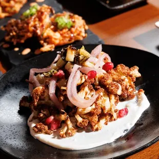 Kari-Furawa (golden fried cauliflower with pickled red onion, honey yuzu yogurt + pomegranate seeds)