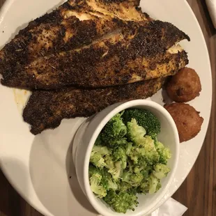 Blackened Red Drum fish and broccoli with hush puppies.