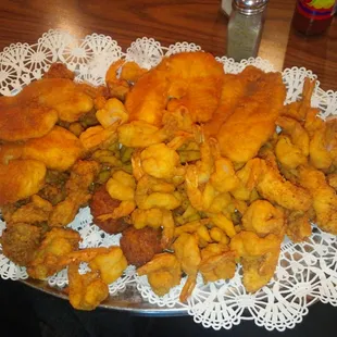 Platter for two: fried shrimp, chicken strips, oysters and fish. Their portion size has decreased since this picture was taken.