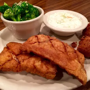 Fried mahi-mahi with a side of broccoli, coleslaw, and hush puppies.