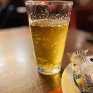 a glass of beer and a bag of chips