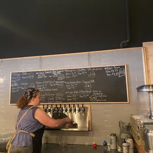 a woman filling up a beer