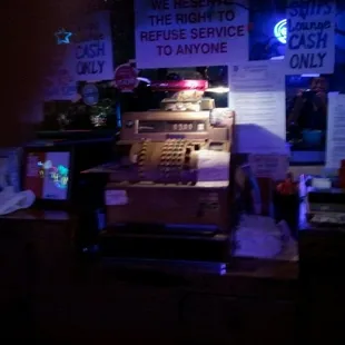 a cash register in a dimly lit room