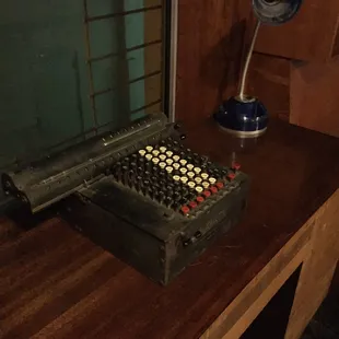 an old typewriter on a wooden desk