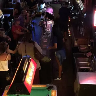 a crowd of people playing a game of pool