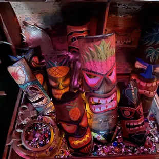 a chest full of tiki masks