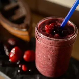 a smoothie with strawberries and cherries