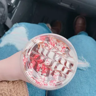 a person holding a cup of ice cream