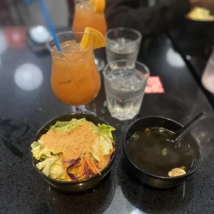 a bowl of salad and a drink