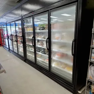 a grocery store aisle with refrigerators