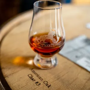 a glass of brandy on a barrel