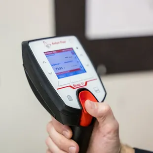 a hand holding a handheld scanner