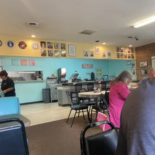 people sitting at tables in a restaurant