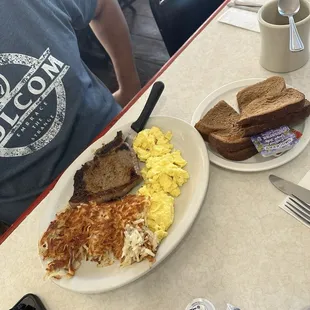 Sirloin steak breakfast with eggs and crispy hashbrowns