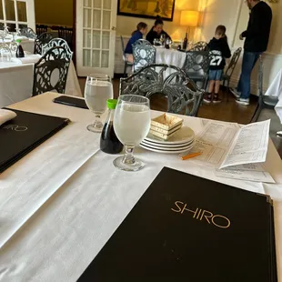 a menu and a glass of water