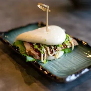 a bun with meat and lettuce on it