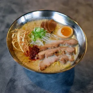 a bowl of ramen with meat and noodles