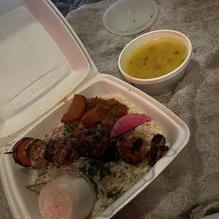 Kebab over rice and  lentil soup