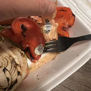 Produce stickers still stuck onto cooked vegetables.