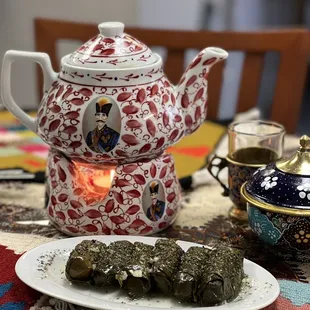 a teapot and a plate of food