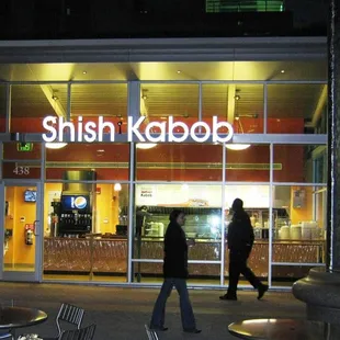 people walking in front of a restaurant