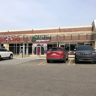 a parking lot with cars parked in front of it
