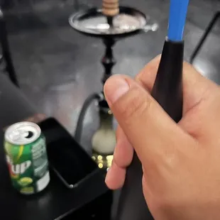 a person holding a blue toothbrush