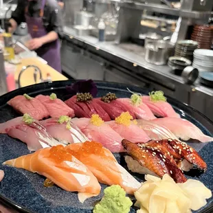 a person holding a plate of sushi