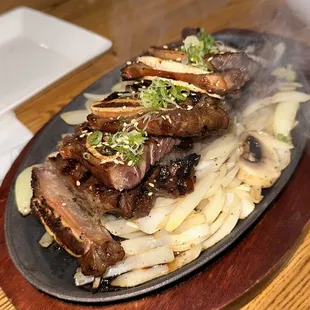 Short Ribs on a bed of onion and mushroom with a side of rice