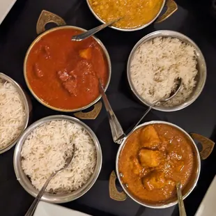 a variety of currys and rice